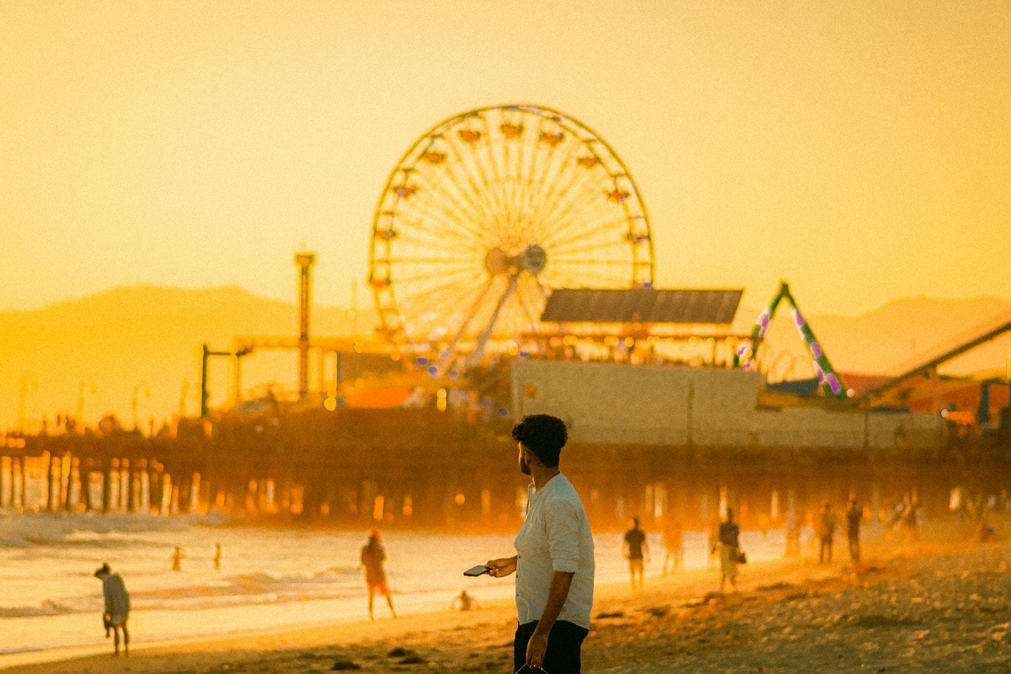 Santa Monica Pier photographed from the beach in warm evening light